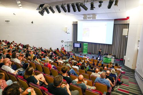 A talk in progress, rows of attendees in the lecture hall.
