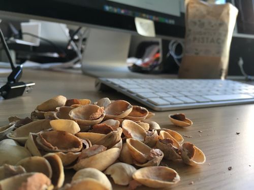 Pistachio shells in front of an iMac (eating Pistachio's whilst working on the Graze pattern library, Pistachio.)