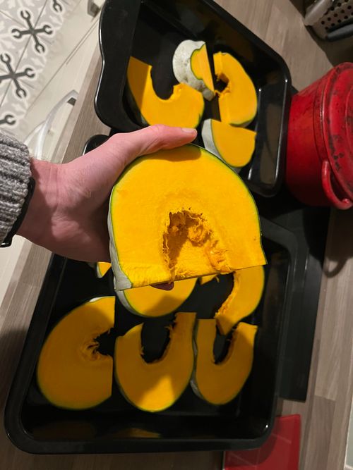 Pumpkin half-moons in a baking tray.