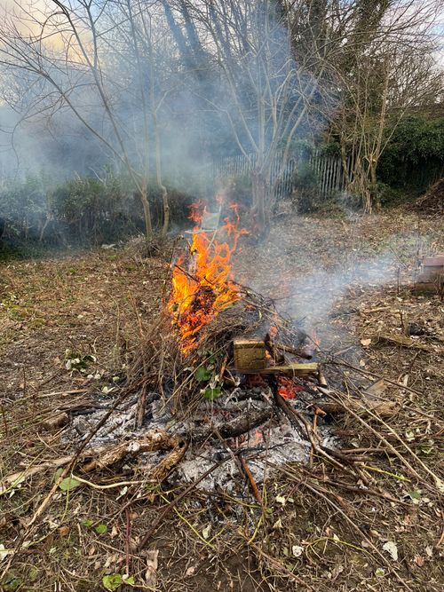 A fire of wood and twigs burns.